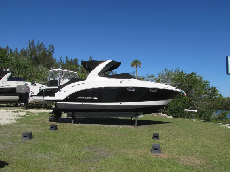 Slide: The Image of 2012 Chaparral Signature boat on land, blue sky background. - 4