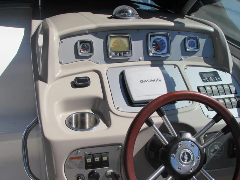 Slide: The Image of 2012 Chaparral Signature boat dashboard with Garmin navigation system and wooden steering wheel. - 8