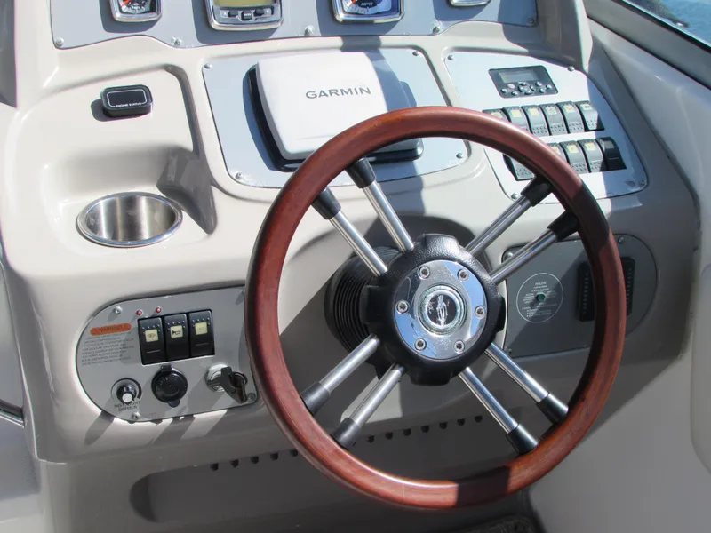 Slide: The Image of 2012 Chaparral Signature boat dashboard with Garmin GPS and wooden steering wheel. - 9