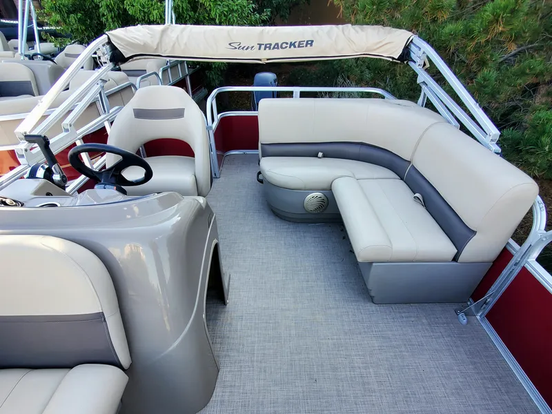 Slide: The Image of 2023 Sun Tracker Party Barge 18 DLX pontoon boat interior with seating and steering console. - 3
