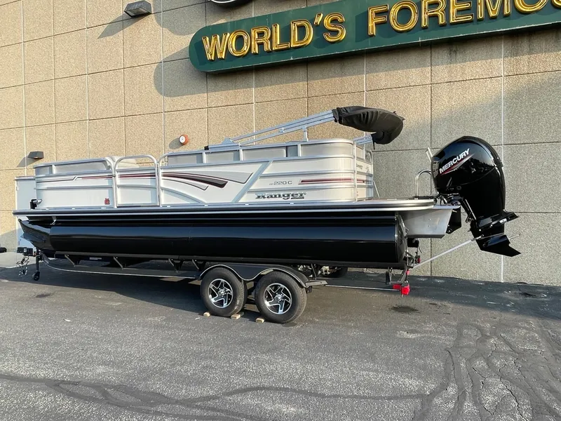 The Image of 2023 Ranger Reata 220C pontoon boat with Mercury outboard motor on trailer. - 0