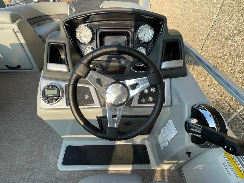 Slide: The Image of 2023 Ranger Reata 220C boat dashboard with steering wheel and control panel. - 5