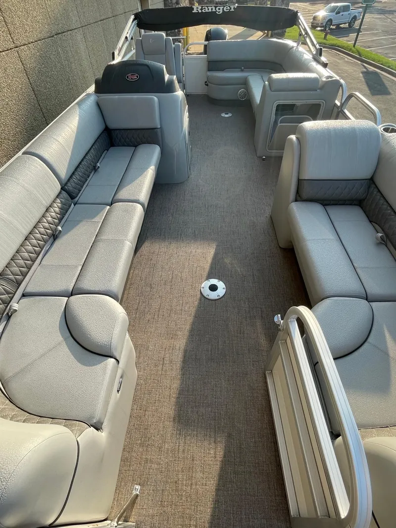 Slide: The Image of 2023 Ranger Reata 220C pontoon boat interior with spacious seating and modern design. - 6