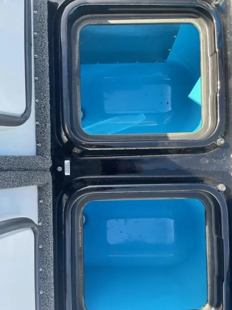 Slide: The Image of 2024 iKon LX21 boat livewell compartments with blue interior. - 6