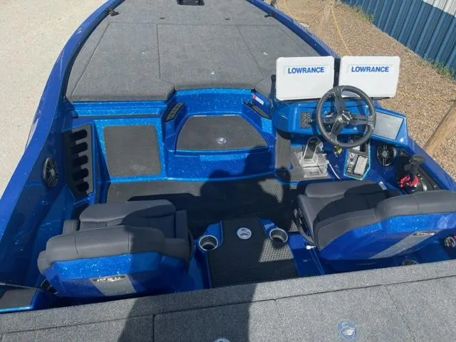 Slide: The Image of 2024 iKon LX21 boat interior with dual Lowrance screens and blue seating. - 7