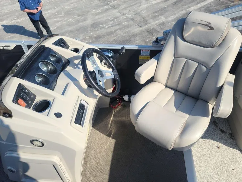 Slide: The Image of 2016 Bennington 20 SS boat interior with steering console and captain's chair. - 12