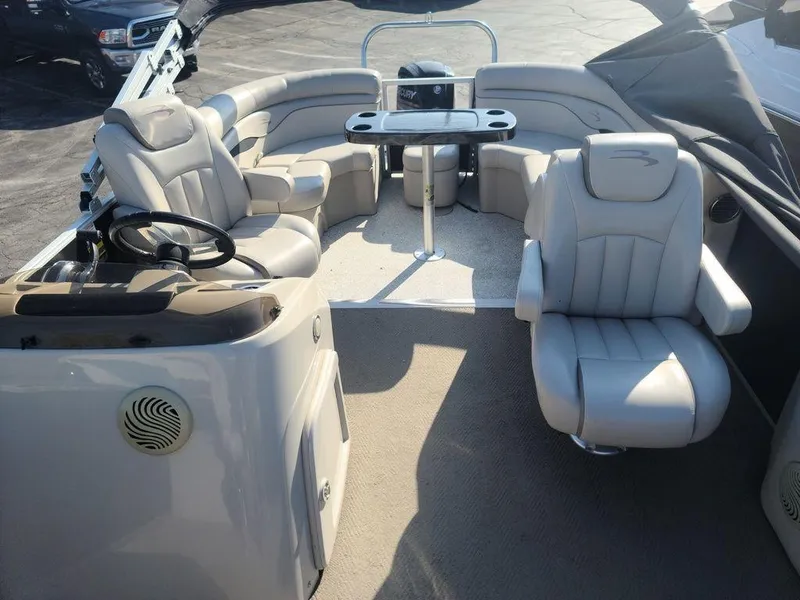 Slide: The Image of 2016 Bennington 20 SS pontoon boat interior with plush seating and steering console. - 5