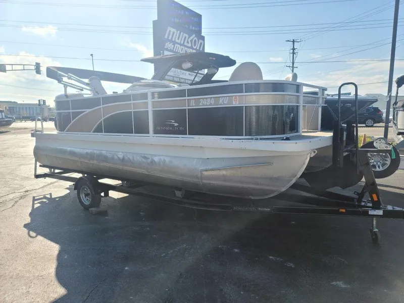 Slide: The Image of 2016 Bennington 20 SS pontoon boat on a trailer in a parking lot. - 6