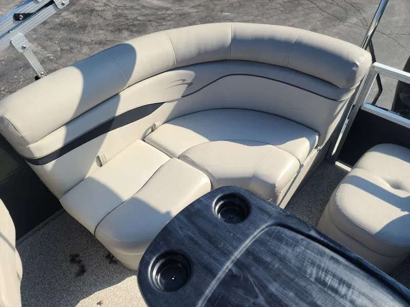 Slide: The Image of 2016 Bennington 20 SS pontoon boat with beige seating and cup holders. - 7
