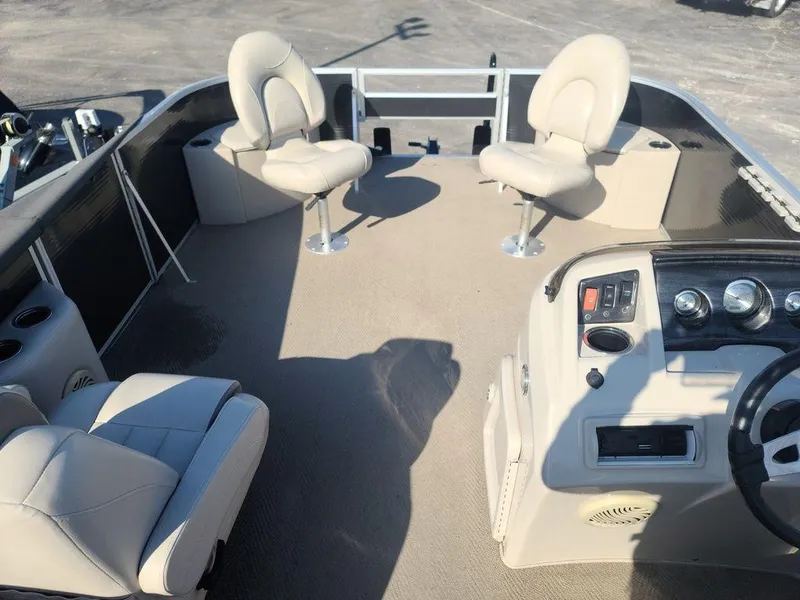 Slide: The Image of 2016 Bennington 20 SS pontoon boat interior with beige seating and steering console. - 8