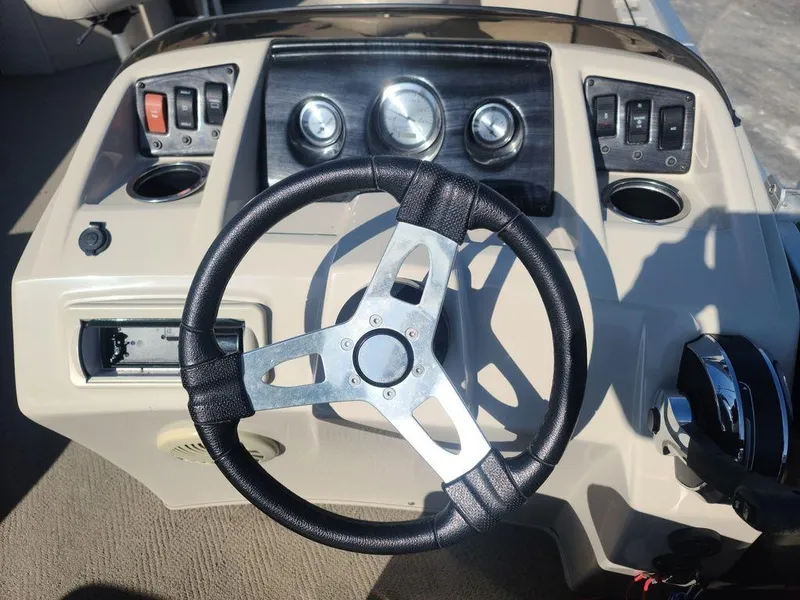 Slide: The Image of 2016 Bennington 20 SS boat dashboard with steering wheel and control panel. - 9