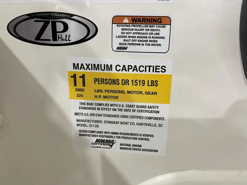 Slide: The Image of 2023 Stingray 211DC boat capacity label: 11 persons or 1519 lbs, 225 HP motor. - 13