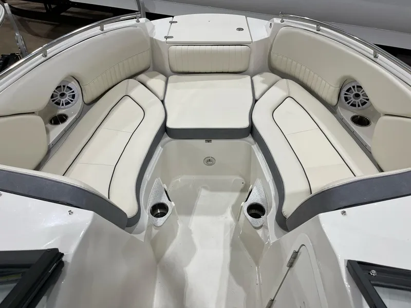 Slide: The Image of 2023 Stingray 211DC boat interior with plush seating and cup holders. - 15
