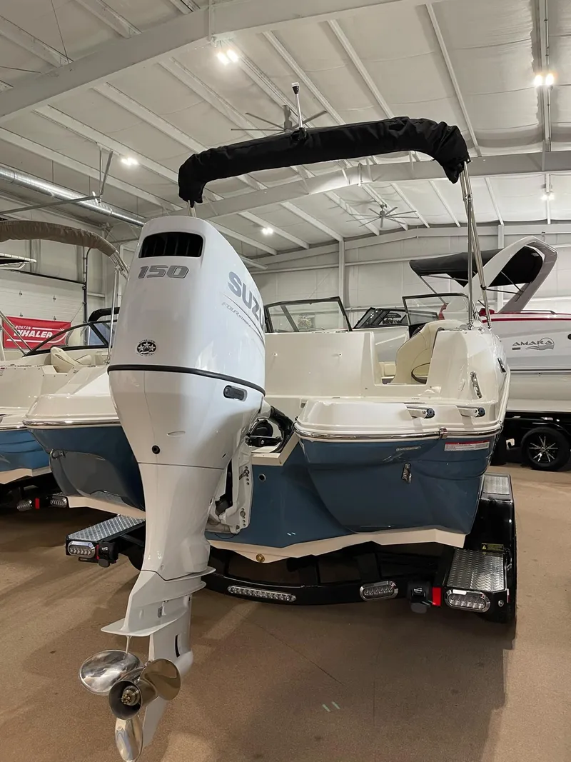 Slide: The Image of 2023 Stingray 211DC boat with Suzuki 150 outboard motor in showroom. - 4
