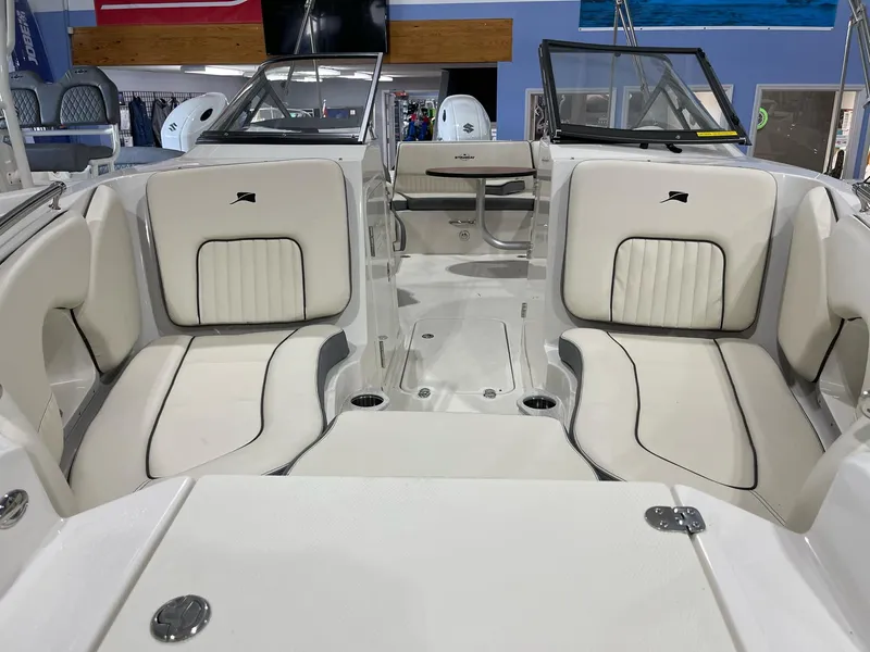 Slide: The Image of 2023 Stingray 211DC boat interior with plush seating and modern design. - 8