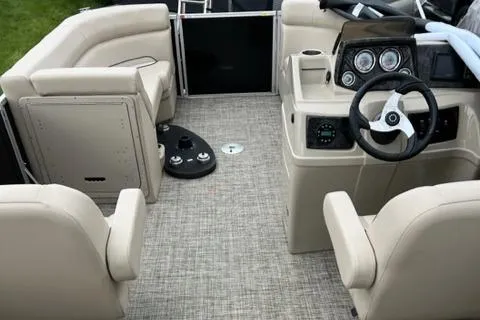 Slide: The Image of 2023 SunCatcher Select 20RC boat interior with beige seating and modern dashboard. - 3