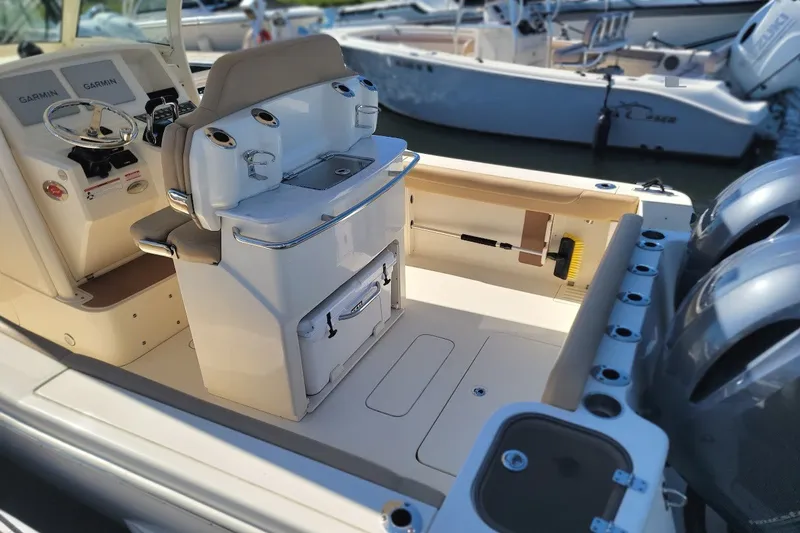 Slide: The Image of 2020 Scout 255 LXF boat interior with helm, seating, and dual engines. - 23
