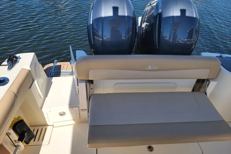 Slide: The Image of 2020 Scout 255 LXF boat with dual engines and beige seating on water. - 12