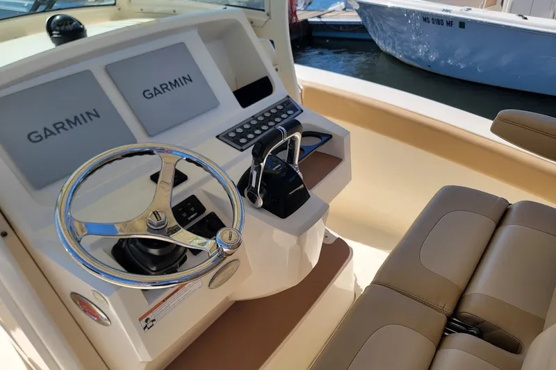 Slide: The Image of 2020 Scout 255 LXF boat helm with Garmin displays and leather seating. - 13