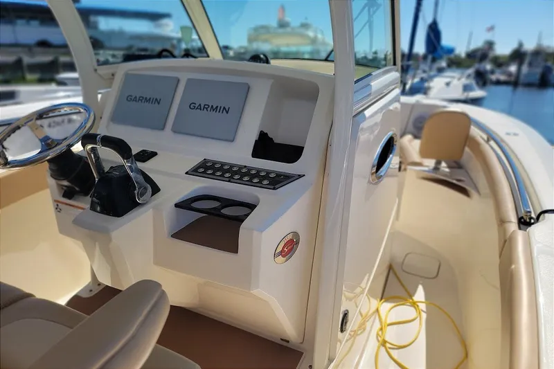 Slide: The Image of 2020 Scout 255 LXF boat dashboard with Garmin displays at marina. - 22