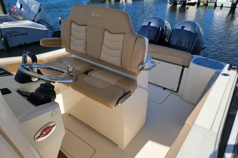 Slide: The Image of 2020 Scout 255 LXF boat interior with dual engines and beige seating. - 8