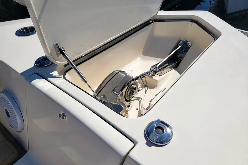 Slide: The Image of Open anchor compartment on 2020 Scout 255 LXF boat, showcasing storage and equipment. - 15