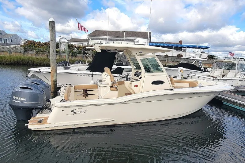 Slide: The Image of 2020 Scout 255 LXF boat docked, featuring Yamaha engines, under a partly cloudy sky. - 35