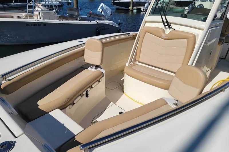 Slide: The Image of 2020 Scout 255 LXF boat interior with beige seating and sleek design. - 5