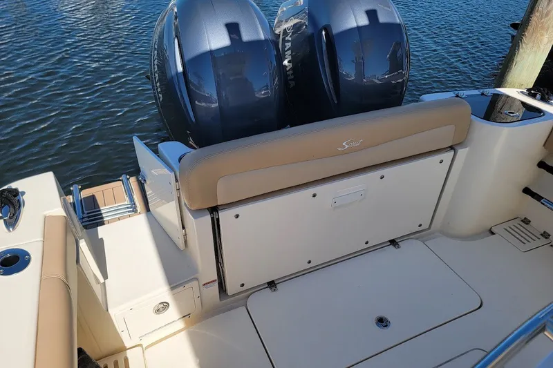 Slide: The Image of 2020 Scout 255 LXF boat with twin Yamaha engines, docked on water. - 11