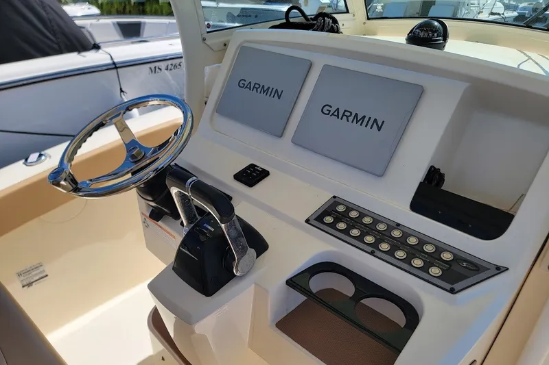 Slide: The Image of 2020 Scout 255 LXF boat dashboard with Garmin displays and steering wheel. - 7