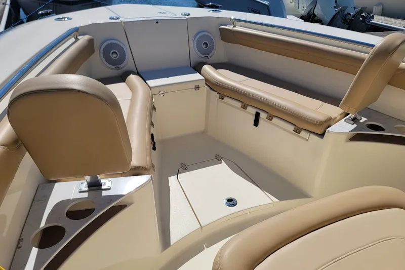 Slide: The Image of 2020 Scout 255 LXF boat interior with tan seating and cup holders. - 14