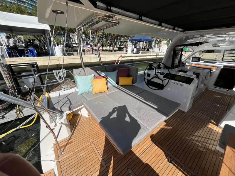 Slide: The Image of Jeanneau 55 (2024) yacht interior with seating area and steering wheel. - 11