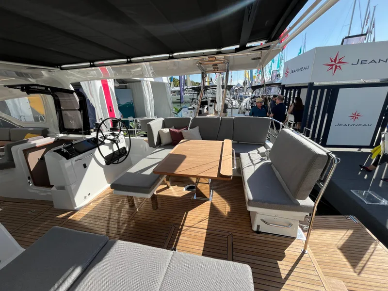 Slide: The Image of 2024 Jeanneau 55 yacht cockpit with seating and dining area. - 12