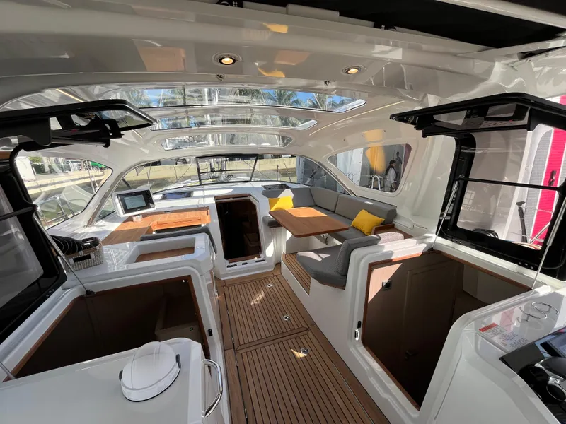 Slide: The Image of Luxurious interior of the 2024 Jeanneau 55 yacht with modern seating and wooden accents. - 14