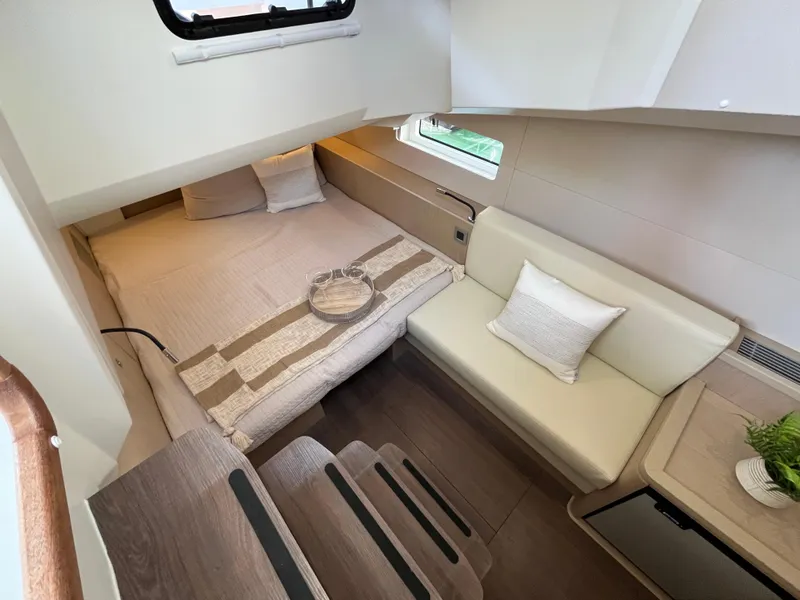 Slide: The Image of Interior cabin of 2024 Jeanneau 55 yacht with bed, sofa, and modern decor. - 18