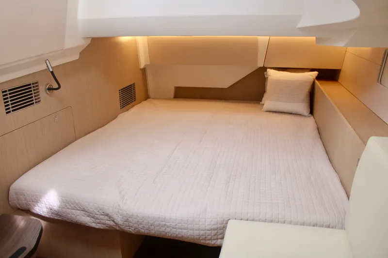 Slide: The Image of 2024 Jeanneau 55 yacht interior cabin with bed and pillow. - 22