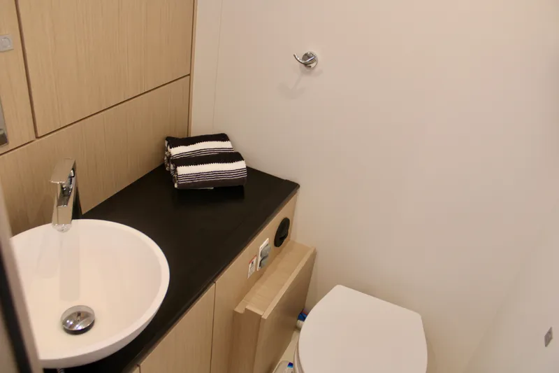 Slide: The Image of Modern bathroom in 2024 Jeanneau 55 yacht with sink, toilet, and countertop. - 23