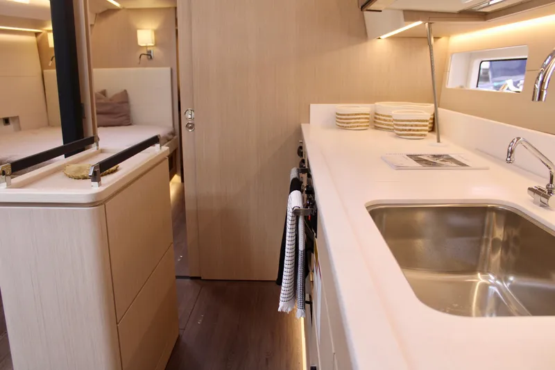 Slide: The Image of Modern kitchen area in 2024 Jeanneau 55 yacht with sleek design and ample lighting. - 27