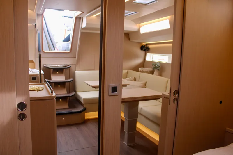 Slide: The Image of 2024 Jeanneau 55 interior with modern dining area and staircase. - 30