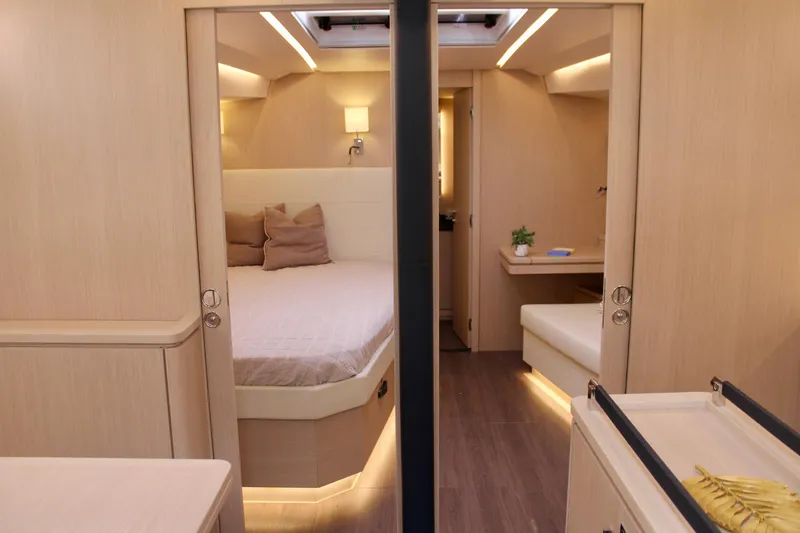 Slide: The Image of Luxurious interior of 2024 Jeanneau 55 yacht with modern bedroom and seating area. - 33