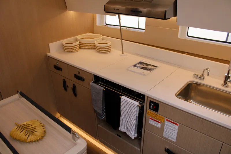 Slide: The Image of Modern kitchen in 2024 Jeanneau 55 yacht with sleek countertops and stainless steel sink. - 35