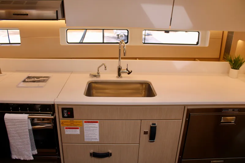 Slide: The Image of Modern kitchen area in 2024 Jeanneau 55 yacht with stainless steel sink and appliances. - 36