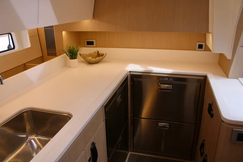 Slide: The Image of Modern kitchen area in 2024 Jeanneau 55 yacht with stainless steel appliances. - 37