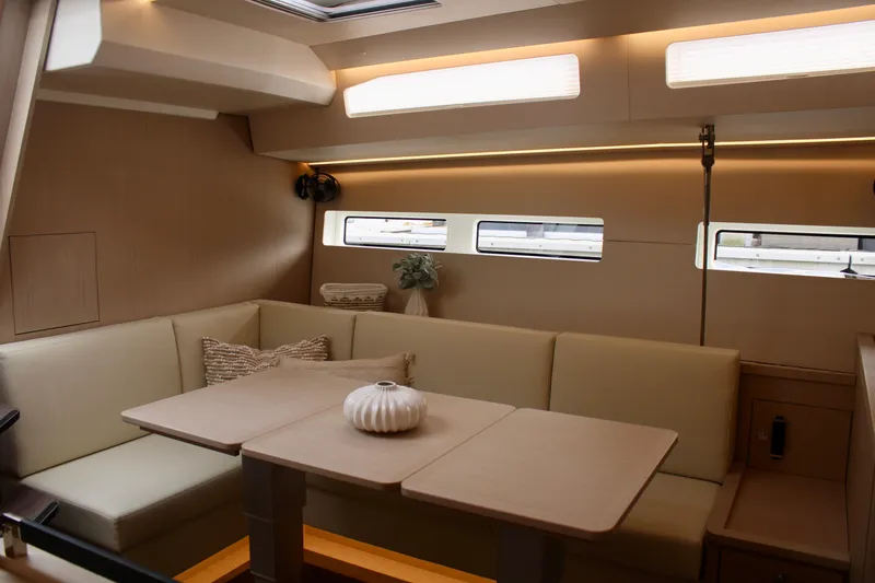 Slide: The Image of Modern interior of 2024 Jeanneau 55 yacht with beige seating and dining table. - 41