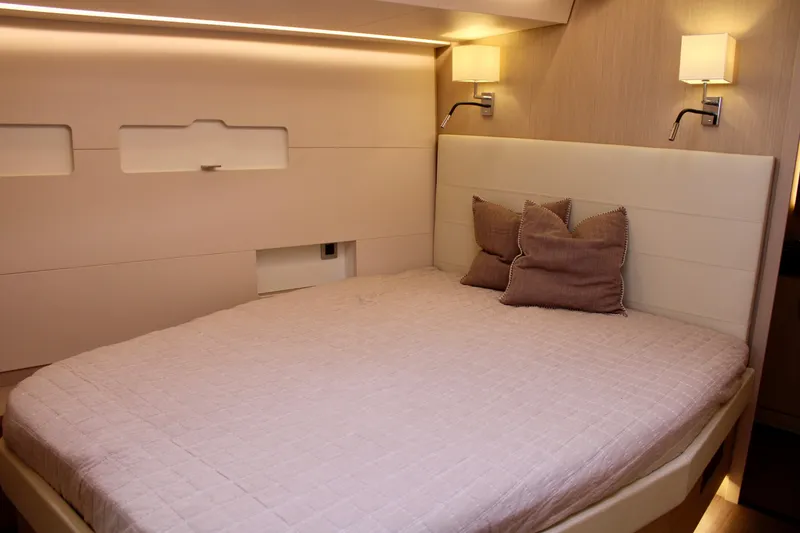 Slide: The Image of Luxurious bedroom in 2024 Jeanneau 55 yacht with modern lighting and cozy bedding. - 45