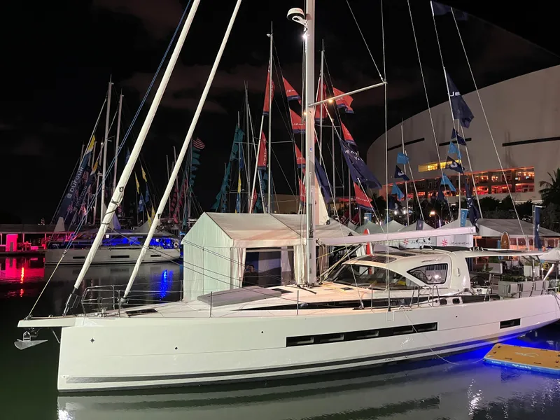 Slide: The Image of 2024 Jeanneau 55 sailboat docked at night with illuminated surroundings. - 5