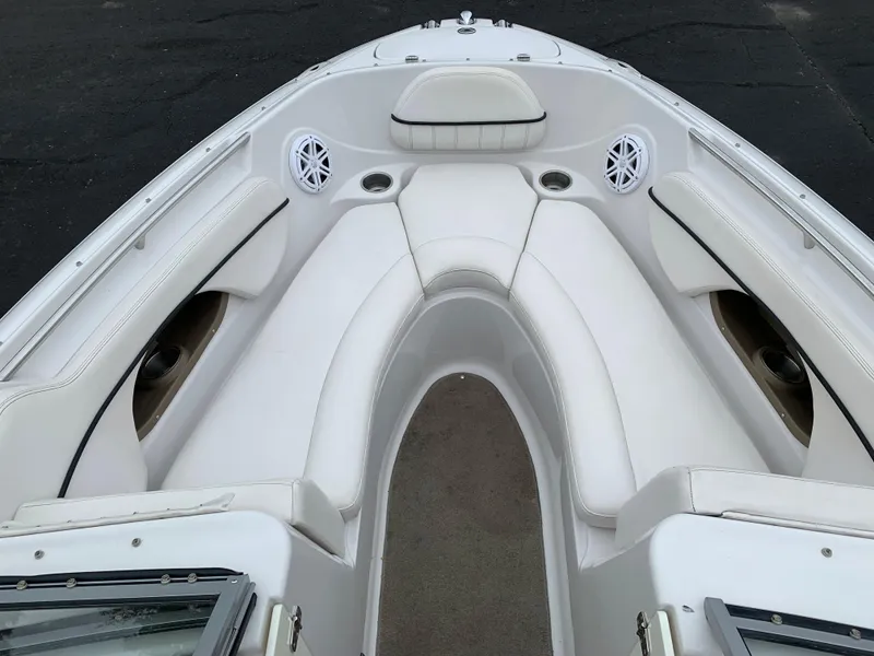 Slide: The Image of 2010 Four Winns H220 boat bow seating area with white upholstery. - 2