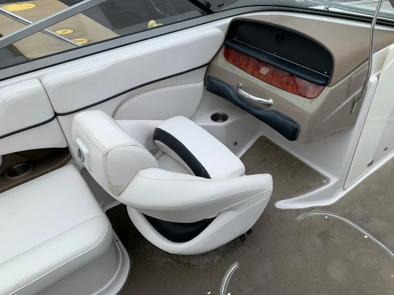 Slide: The Image of 2010 Four Winns H220 boat interior with white leather seats and dashboard. - 6