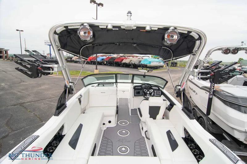 Slide: The Image of 2023 MasterCraft NXT22 boat interior with white seating and black accents. - 12