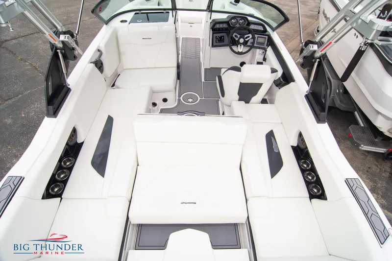 Slide: The Image of 2023 MasterCraft NXT22 boat interior with white seating and modern dashboard. - 14